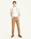 Front view of model wearing Otter Men's Slim Fit Smart 360 Flex Jean Cut Pants.