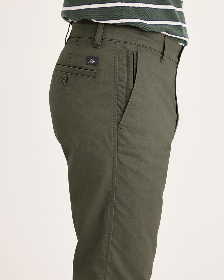Side view of model wearing Parkfied Buttercream Crown Blue Men's Slim Fit Smart 360 Flex Ultimate Chino Pants.