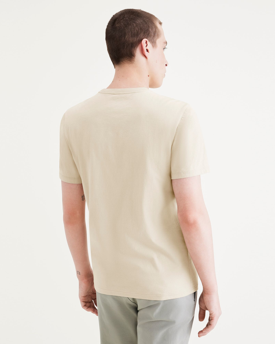 Back view of model wearing Pastime Buttercream Seedling Men's Slim Fit Logo Tee.