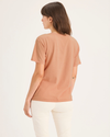 Back view of model wearing Peach Bloom Women's Deep V-Neck Tee Shirt.
