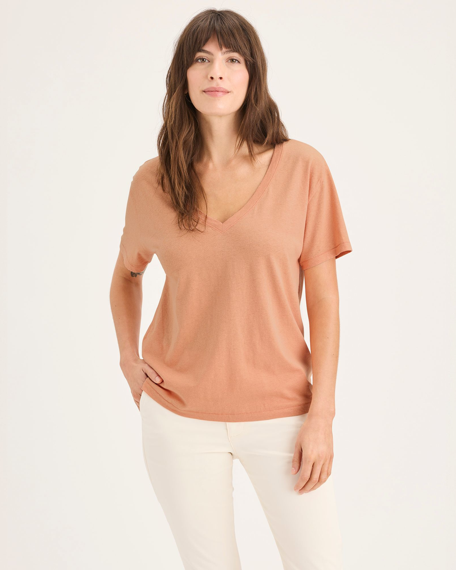 Front view of model wearing Peach Bloom Women's Deep V-Neck Tee Shirt.