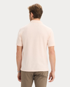 Back view of model wearing Peach Blush Pique Polo, Slim Fit.