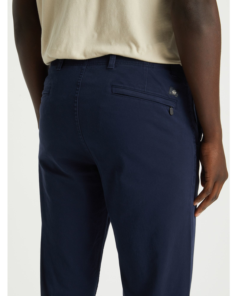View of model wearing Pembroke Men's Slim Fit Smart 360 Flex Alpha Khaki Pants.
