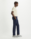 Side view of model wearing Pembroke Men's Slim Fit Smart 360 Flex Alpha Khaki Pants.
