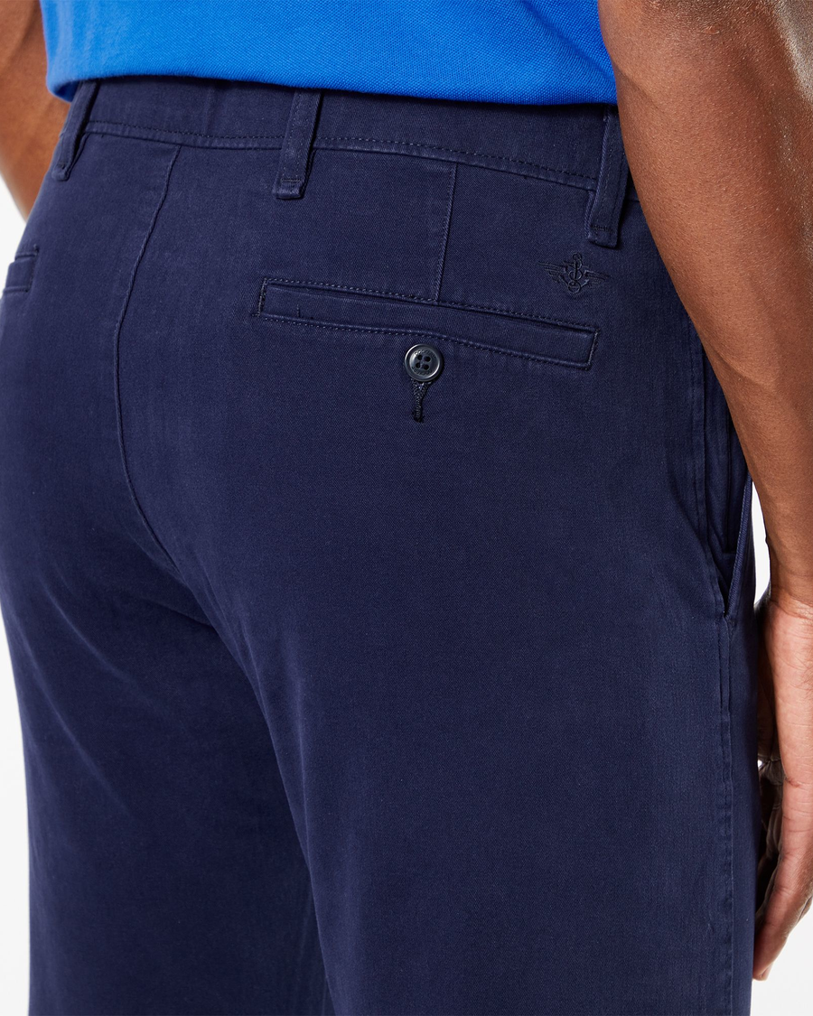 View of model wearing Pembroke Men's Slim Fit Smart 360 Flex Ultimate Chino Pants.