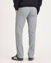 Back view of model wearing Sharkskin Alpha Chino Pants, Slim Fit.