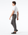 Side view of model wearing Storm Workday Khaki Pants, Slim Fit.