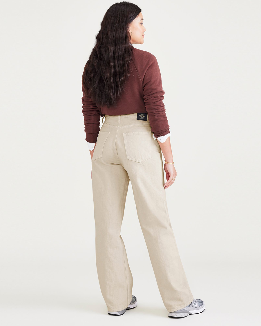 Back view of model wearing Tan Garment Dye Women's Relaxed Fit Mid-Rise Jeans.