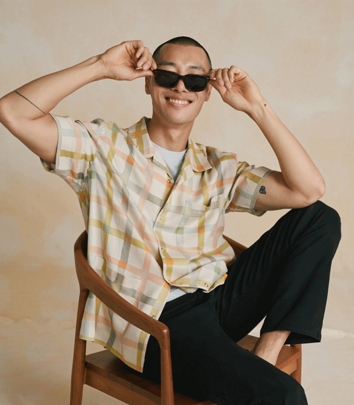 Dockers® men’s and women’s summer outfits styled for vacation, featuring lightweight shirts, shorts, and chinos.
