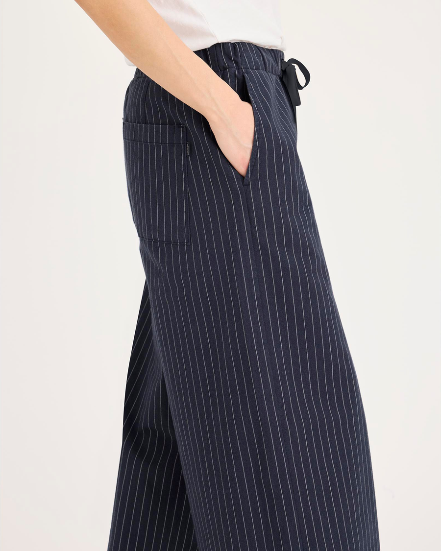 Side view of model wearing Total Eclipse Drawsting Pant, Regular Fit.