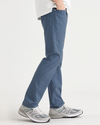 Side view of model wearing Vintage Indigo Men's Slim Fit Smart 360 Flex Jean Cut Pants.